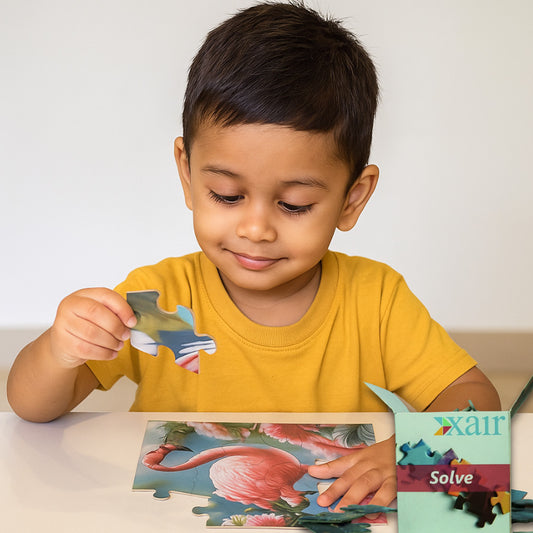 Child playing with a puzzle featuring a flamingo, with a Xair Solve product in the background.